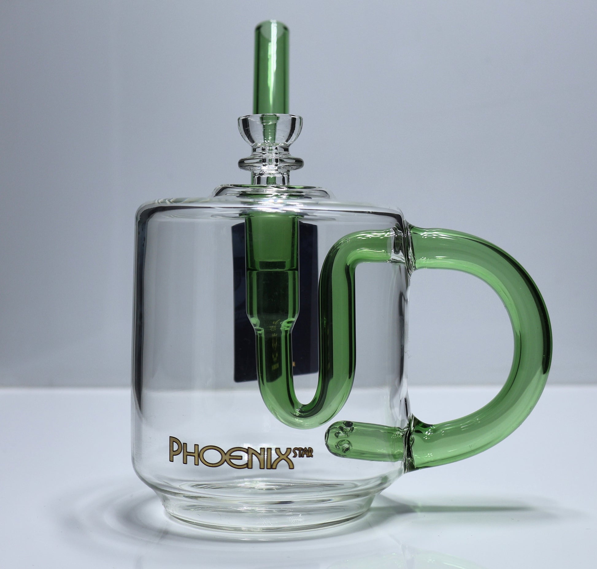 Clear glass mug shape with green handle and straw on a white surface background