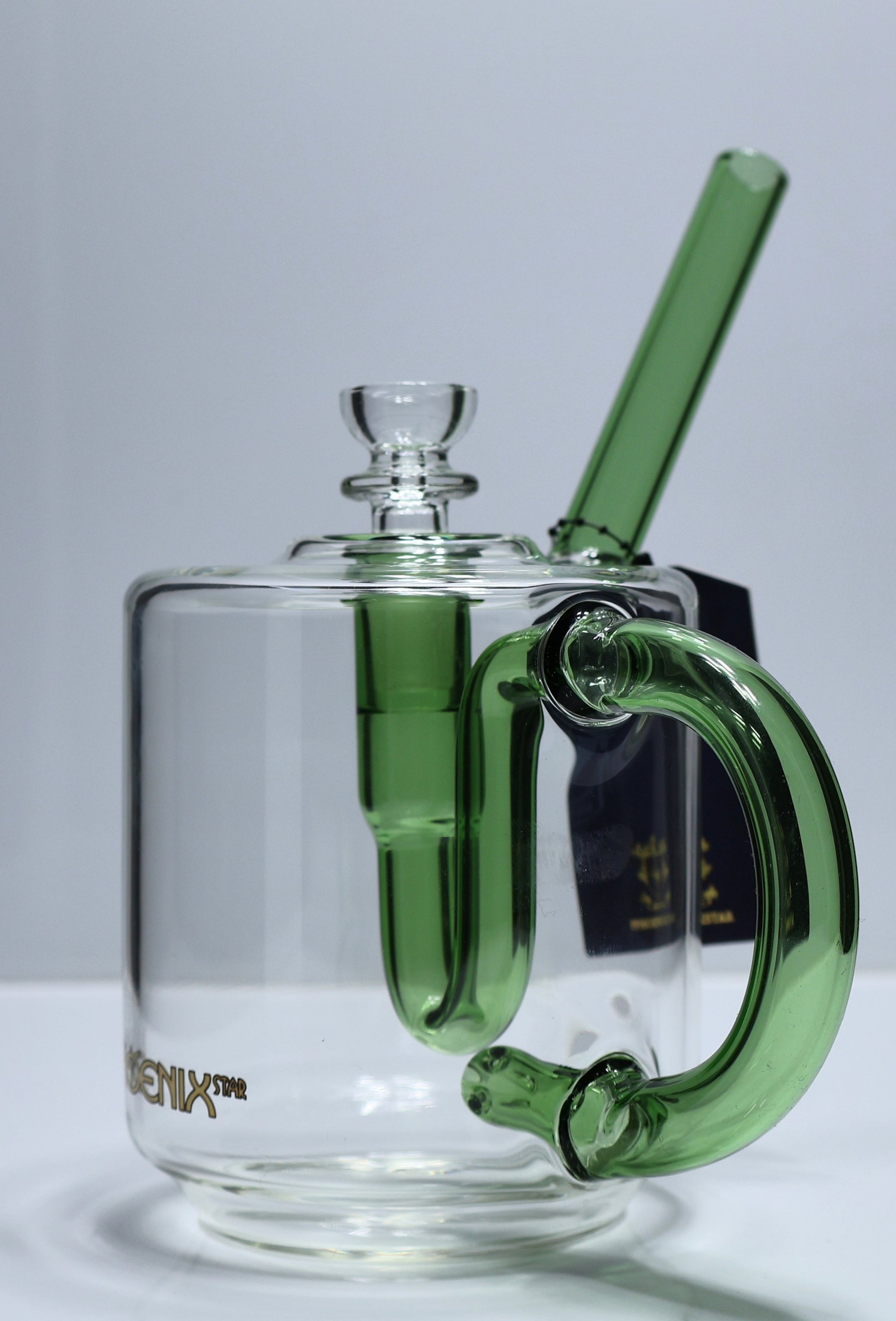 Clear glass mug with green handle and straw on a white background